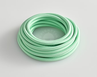 May include: A coiled mint green electrical cable. The cable has a braided texture and is neatly wound. The word "BRIGHTTIA" is printed at the bottom of the image.