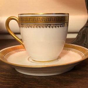 W Guerin & Co White Two Handles Porcelain Teacup and Saucer With Gold Trim  