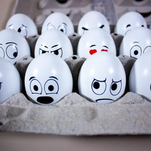 May include: A white ceramic mug with a black handle and the text "But First, Coffee" in a black, bold font. The mug is on a white surface.