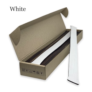 May include: A box of white trim molding, with the molding partially pulled out of the box. The molding is white and has a wood grain texture. The box is brown cardboard with a white label on the bottom.