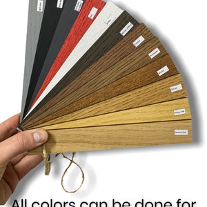 May include: A color chart showing different wood finishes for a product. The finishes include light gray, deep black, dark gray, red, white, walnut, rosewood, cypress, oak oil, yellow oak, and natural oak.