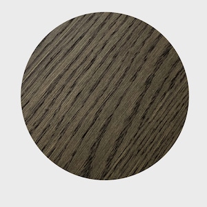 May include: A close-up of a dark gray wood grain surface. The surface is smooth and has a natural wood grain pattern.