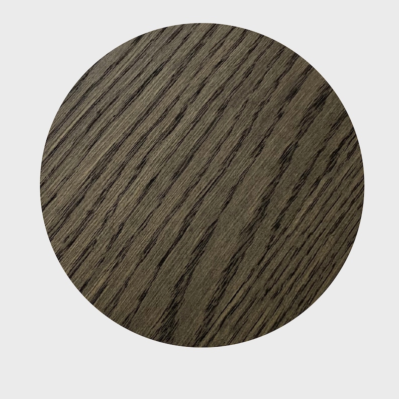 May include: A close-up of a dark gray wood grain surface. The surface is smooth and has a natural wood grain pattern.