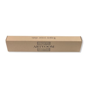 May include: A rectangular, light brown cardboard box featuring the black text "ARTVOOM" centered above a wood grain graphic, with the phrase "Enjoy your slats" printed in black text along the top edge of the box's front panel.