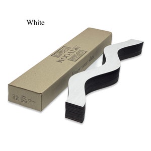 May include: A stack of white wooden slats in a wavy pattern, packaged in a brown cardboard box. The box has the text "ARTWOOD" and "Enjoy your slats" printed on it. The slats are labeled "White".
