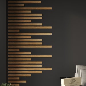 May include: A dark grey wall with a wood accent wall made of horizontal wood strips. There is a small plant in a pot on the floor and a stack of two boxes on a black table. The boxes are labelled "ARTVOOM" and "artvoom.com".