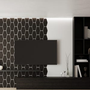 May include: A wall-mounted television centered on a dark brown hexagonal tile accent wall. Below the television is a long, dark wood media console and a floating shelf. To the right, a tall black shelving unit holds books and decorative objects.