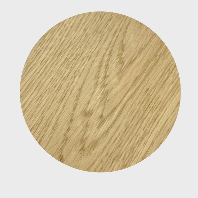 May include: A close-up of a light brown wood grain surface. The surface is smooth and has a natural wood finish.