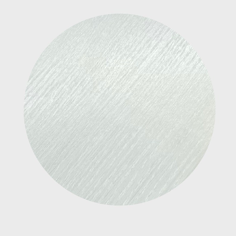 May include: A white circle with a textured surface.