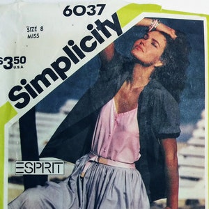 May include: Simplicity sewing pattern number 6037 for a skirt. The pattern is for size 8 miss and costs $3.50. The pattern shows a woman wearing a blue skirt with a pink top and a black jacket. The pattern also shows two other women wearing skirts.