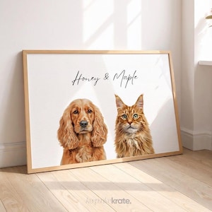 May include: A framed print featuring a golden Cocker Spaniel and a ginger tabby cat. The artwork has the text "Honey & Maple" in script. The print is in a light wood frame, set against a white background.