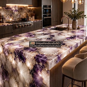 May include: A kitchen island countertop made of polished purple and white amethyst stone slabs with a translucent quality. A black rectangular sign with white text reads UniqueHandicraftsIND and www.etsy.com/shop/uniquehandicraftsind.