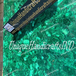 May include: A close-up of a green malachite stone surface with a black label that reads "Unique HandicraftsIND" and the website address "www.etsy.com/shop/uniquehandicraftsind".
