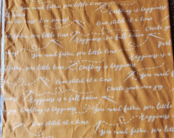 Crafting/Sewing Themed Fleece Fabric: Golden Rod Background with phrases in white cursive (each cut is pre-cut to 1.5 yards)