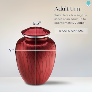 May include: Red metal urn with a swirling pattern, measuring 9.5 inches tall and 7 inches wide.  Suitable for holding the ashes of an adult up to approximately 200 lbs.  15 cups approx.
