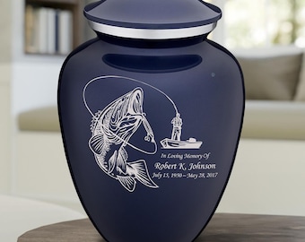 May include: Navy blue cremation urn with a lid and silver trim. A white graphic depicts a fish jumping for a fishing lure, with a fisherman in a boat. Text reads "In Loving Memory Of Robert K. Johnson July 15, 1950 - May 28, 2017."