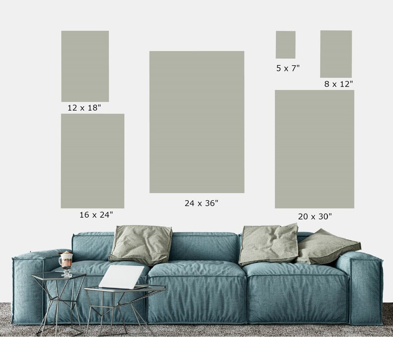 May include: Five different sizes of framed artwork with a light gray background. The frames are all the same color and style. The artwork is displayed on a white wall above a blue sofa.