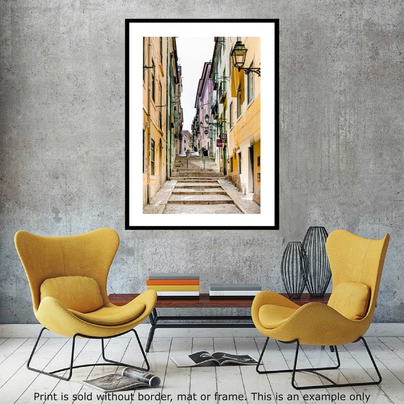 May include: A narrow, cobblestone street in a European city with colorful buildings on either side. The street leads up a set of stairs to a building with a sign that reads "Casa da Musica".