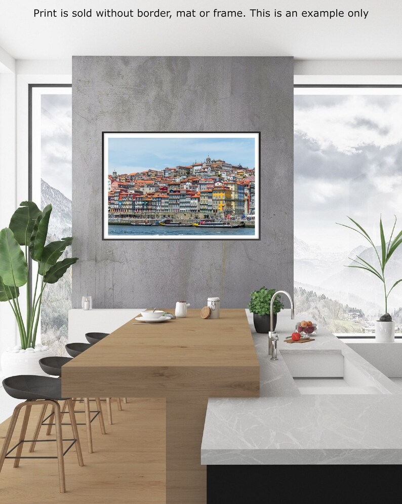 May include: A photograph of a cityscape with colorful buildings along a waterfront. The buildings are clustered together and have a variety of architectural styles. The water is calm and reflects the sky.