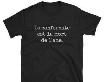 May include: Black t-shirt with white text that reads "La conformite est la mort de l'ame."
