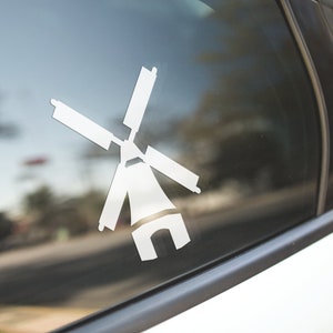 May include: A white vinyl sticker of a windmill silhouette on a car window.