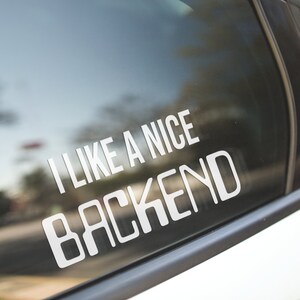 May include: A white vinyl sticker on a car window that says "I like a nice backend".