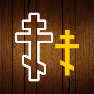 May include: Two crosses, one white and one yellow, on a woodgrain background. The white cross is larger and has a more intricate design. The yellow cross is smaller and simpler.