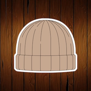 May include: A brown knitted beanie with a folded brim.