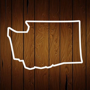 May include: A white outline of the state of Washington against a dark brown wood grain background. The wood grain has vertical lines and a natural wood texture. The state outline is clean and simple.