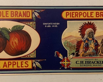 May include: A vintage label for Pierpole Brand Maine Apples. The label features a red, white, and blue illustration of a Native American man in a headdress, holding a bow and arrow. The label also features a red and green illustration of two apples. The text on the label reads "Pierpole Brand", "Maine Apples", "Contents Weigh 5 lbs. 14 oz.", "Packed by C.H. Brackley, Strong, Maine."