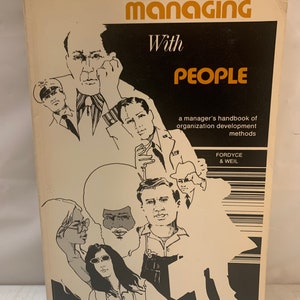 May include: A vintage book cover with the title "Managing With People" in black and orange text. The cover features a black and white illustration of a group of people with diverse appearances.