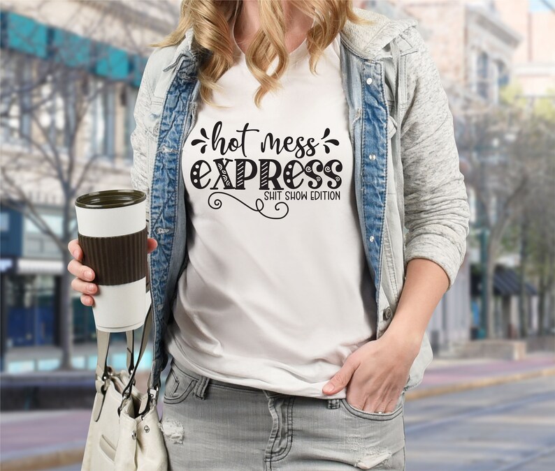 May include: White t-shirt with black text that reads "hot mess express shit show edition".