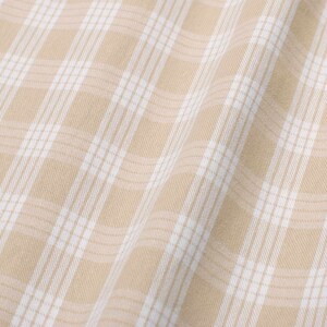 May include: Beige fabric with a white checkered pattern. The fabric is folded and has a soft, textured appearance.