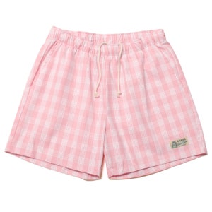 May include: Pink and white checkered shorts with a drawstring waist and a small logo patch that says "LANIS National Store" on the right side.