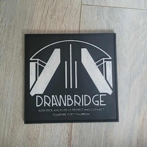 May include: A black square featuring the word "DRAWBRIDGE" in white, accompanied by a bridge graphic. The text "BOTH SICK AND HOPE TO PROTECT AND CONNECT TOGETHER FOR TOMORROW" is below the main text.