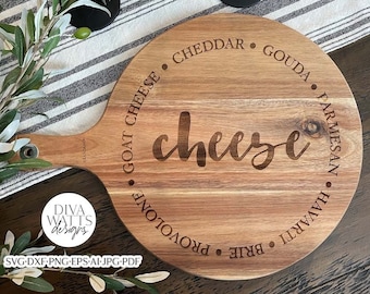 May include: A round wooden cheese board with a handle. The board is engraved with the word "cheese" in a cursive font and a circle of different cheese types: Cheddar, Gouda, Parmesan, Havarti, Brie, Provolone, and Goat Cheese.