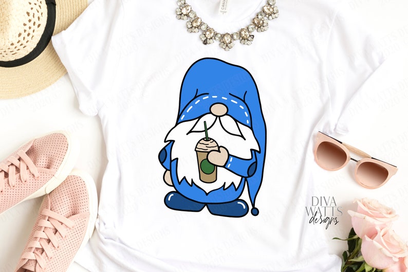 May include: A white t-shirt with a blue gnome holding a coffee cup. The gnome has a white beard and a blue hat with white stitching. The text "Diva Watts Designs" is in the bottom right corner of the image.