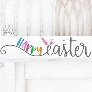 May include: A white wooden sign with the text "Happy Easter" in colorful letters. The word "Happy" is in rainbow colors and the word "Easter" is in gray. There are bunny ears in pink and white above the word "Easter".