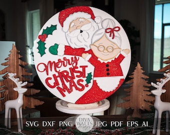 May include: A white round wooden sign with a red and white glitter background. The sign features a cartoon Santa Claus and Mrs. Claus with the text "Merry Christmas!" in red and white letters.