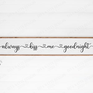 May include: A wooden sign with the text "always kiss me goodnight" in black cursive font with small hearts between each word.
