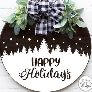 May include: A round wooden sign with a white background and black text that reads "Happy Holidays". The sign is decorated with a black and white checkered bow and a white silhouette of a snowy forest.