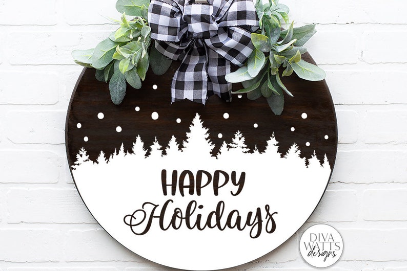May include: A round wooden sign with a white background and black text that reads "Happy Holidays". The sign is decorated with a black and white checkered bow and a white silhouette of a snowy forest.
