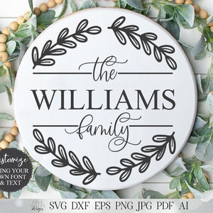 Peut inclure: Une pancarte ronde blanche avec du texte noir et des motifs de feuilles. Le texte indique "the WILLIAMS family".