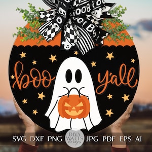 May include: A black and orange round wooden sign with a white ghost holding an orange pumpkin. The sign says "boo yall" with white stars on a black background.