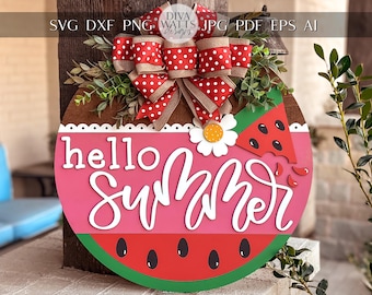 May include: A wooden watermelon-shaped door hanger with a red and white polka dot bow, green leaves, and the text "hello summer" in white lettering.