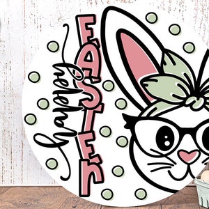 May include: A white bunny with pink ears and green bow wearing glasses with the text "Happy Easter" in black script and "Easter" in pink letters with a white outline on a white background with green polka dots.