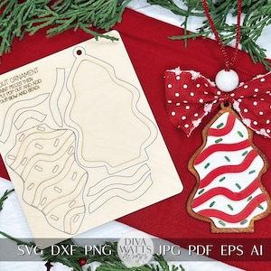 May include: A wooden Christmas tree ornament craft kit with a red and white striped tree design. The kit includes a laser-cut wooden tree shape, a bow, and beads. The text "POP OUT ORNAMENT" is printed on the wood.