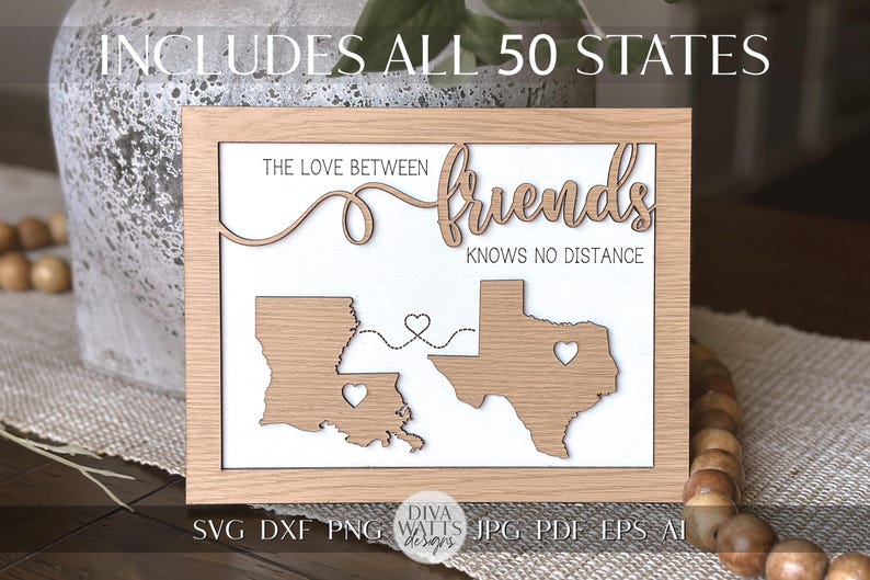 May include: A wooden sign with the text "The love between friends knows no distance" and an outline of the states of Louisiana and Texas. The sign is on a brown surface with a string of wooden beads.