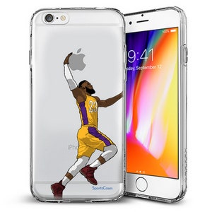 May include: A clear phone case with a cartoon illustration of a basketball player wearing a yellow and purple jersey with the number 23. The player is in mid-air, about to dunk the ball. The phone case is designed for an iPhone.