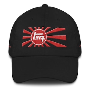May include: A black baseball cap with a red and white embroidered Japanese rising sun design and the Toyota logo in the center.